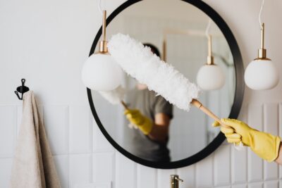 Person holds fluffy duster. Pexels.com