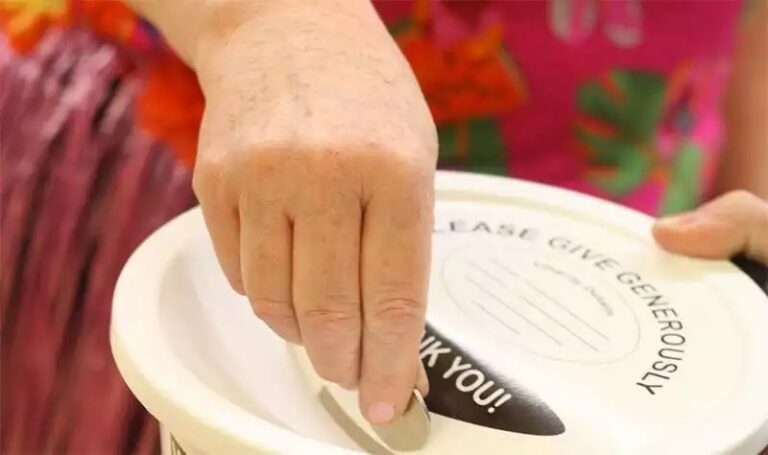 Coin placed in a charity collecting bucket