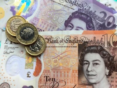 Ten & twenty pound notes with three pound coins copyright Melanie May