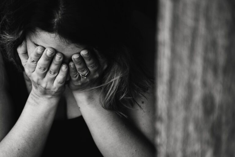 Woman with her head in her hands Photo by Kat Jayne from Pexels