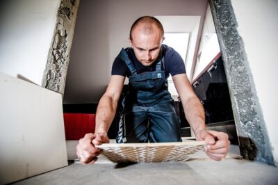 A builder laying tiles