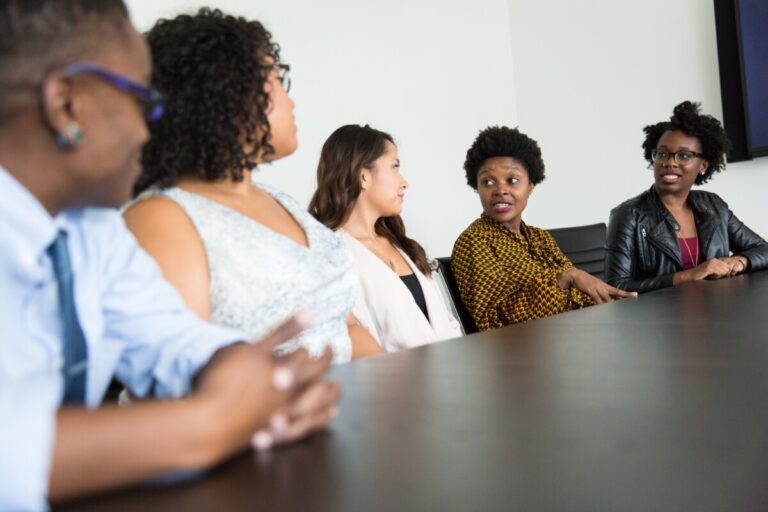 Five business people sitting at a table