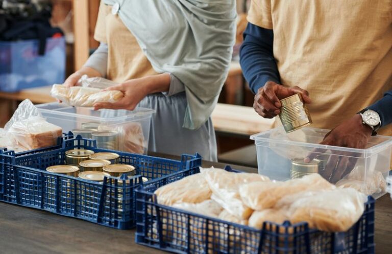 two people sorting food donations