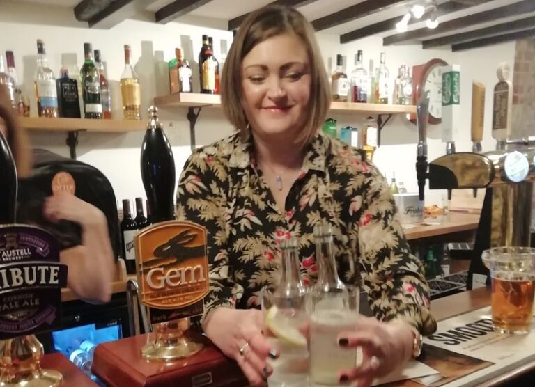 Bar staff at a pub picking up up drinks