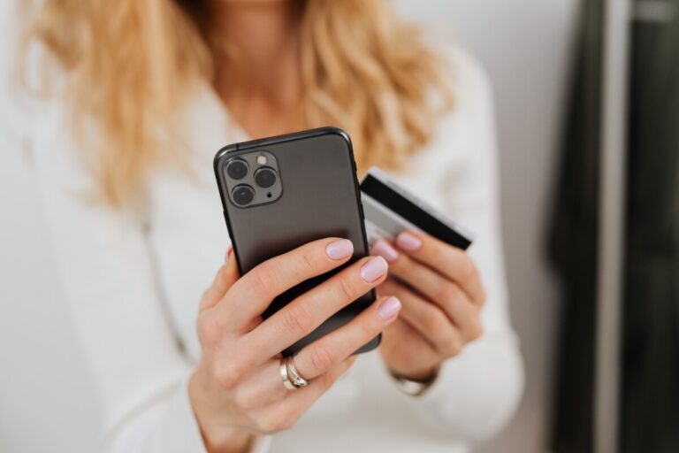 A woman paying with her card on her phone