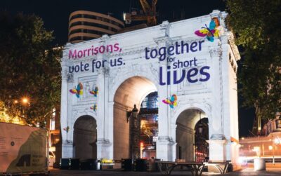 Marble Arch lit up at night by Together for Short Lives