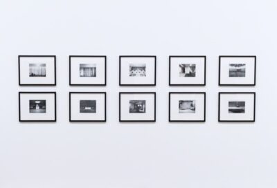 Framed black and white photos on a plain wall. Photo: Pexels.com