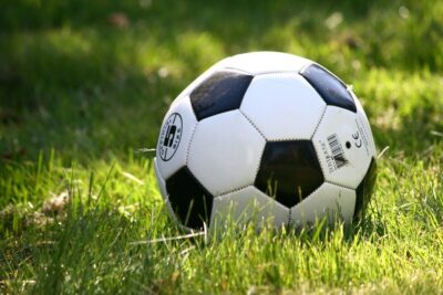 Black and white football on grass