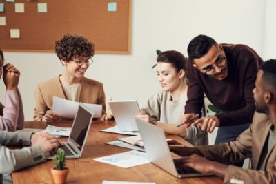 Group of people around a table at work. Photo: Pexels.comq