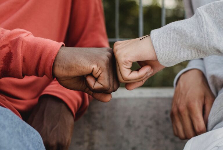 two hands fist bump