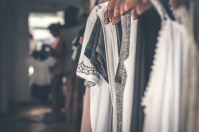 black white and grey womens tops on hangers on a clothes rail