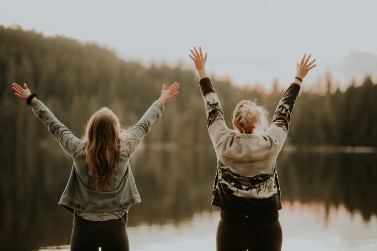 Women cheering by the lake