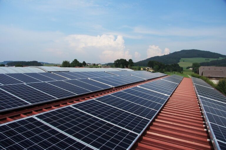 solar panels on a roof with a hill in the background