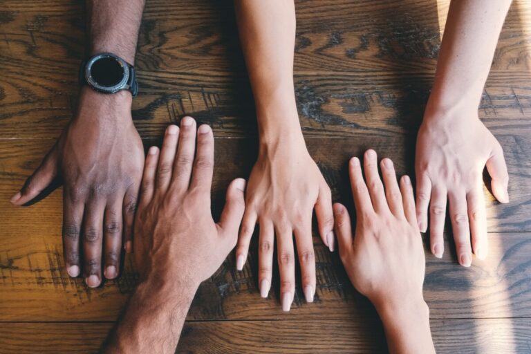 a row of hands by Clay Banks on Unsplash