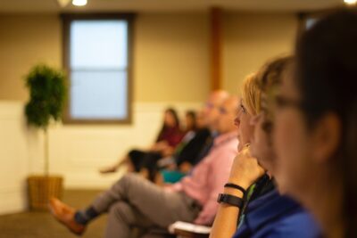 the front row of people listen to a talk