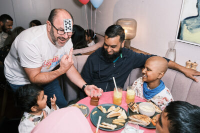 A family enjoys a Mildreds Restaurants & Spread a Smile afternoon tea part