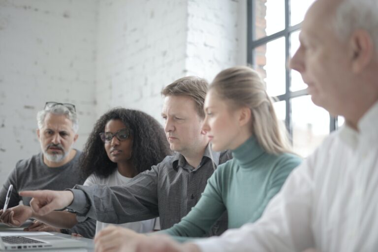 A group of people in a white meeting room