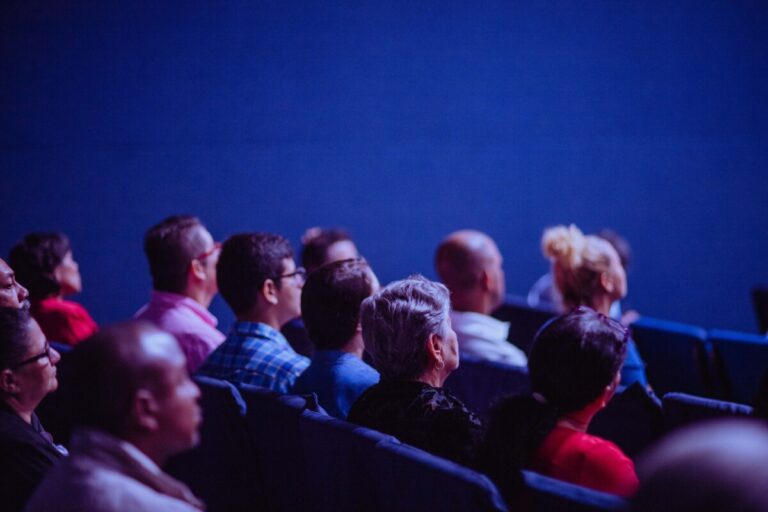 an audience in a darkened room