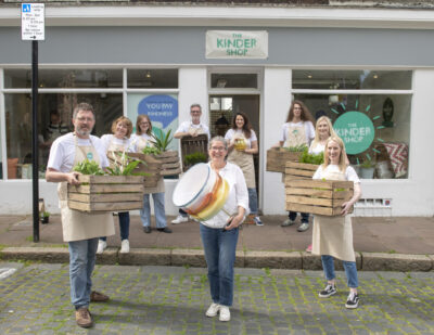 People stand with items for sale outside a pop up Kinder Shop, where people paid with kindness not money