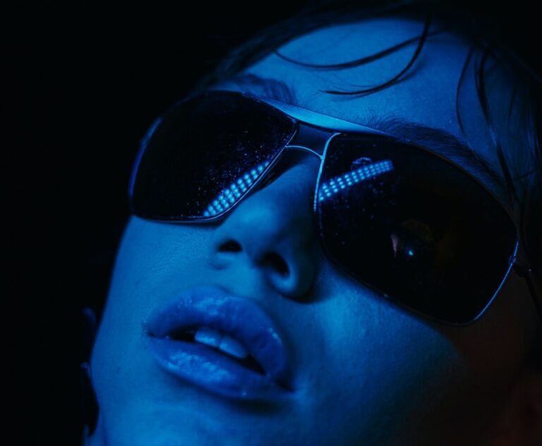 Twitter blue coloured face of a woman wearing sunglasses. Photo: Pexels.com