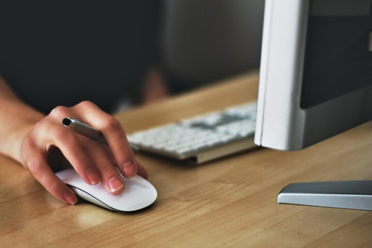 A woman's hand on a computer mouse. By Vojtech Okenka