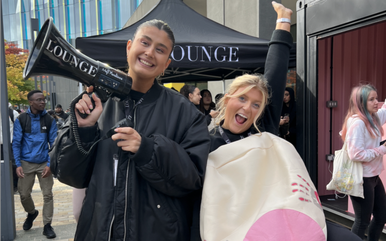 Lounge representatives with a loudspeaker and a big fake boob.