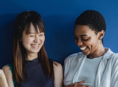 two teen girls laugh. By Zen Chung on Pexels