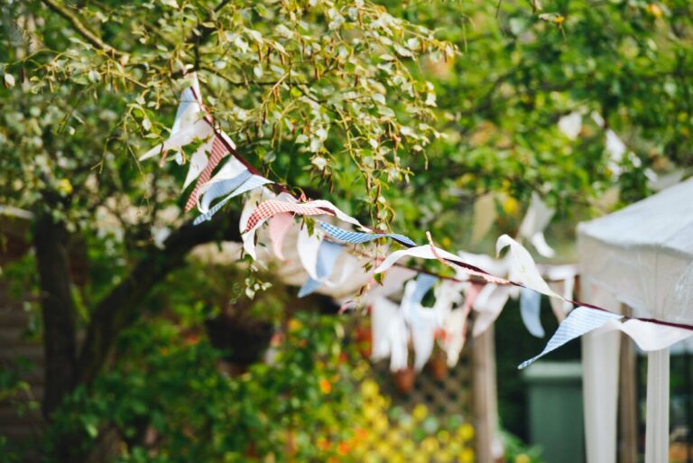 A row of red, white and blue bunting blows in the breeze. By Stokpic on Pixabay