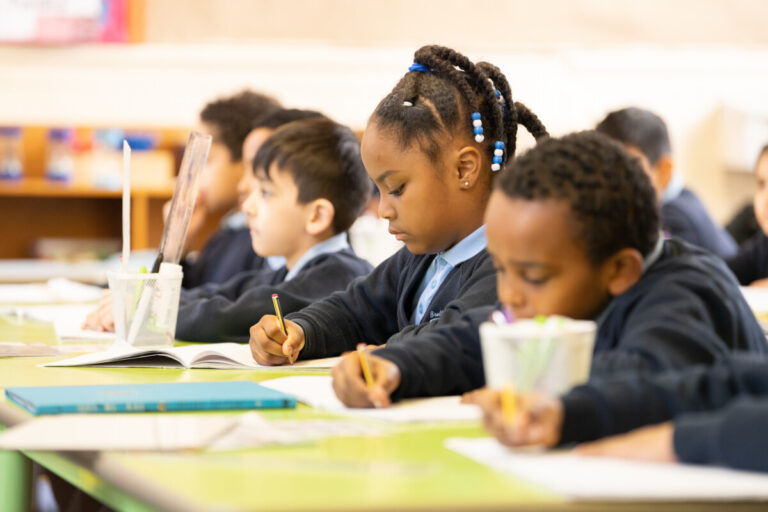 A row of primary school children hard at work