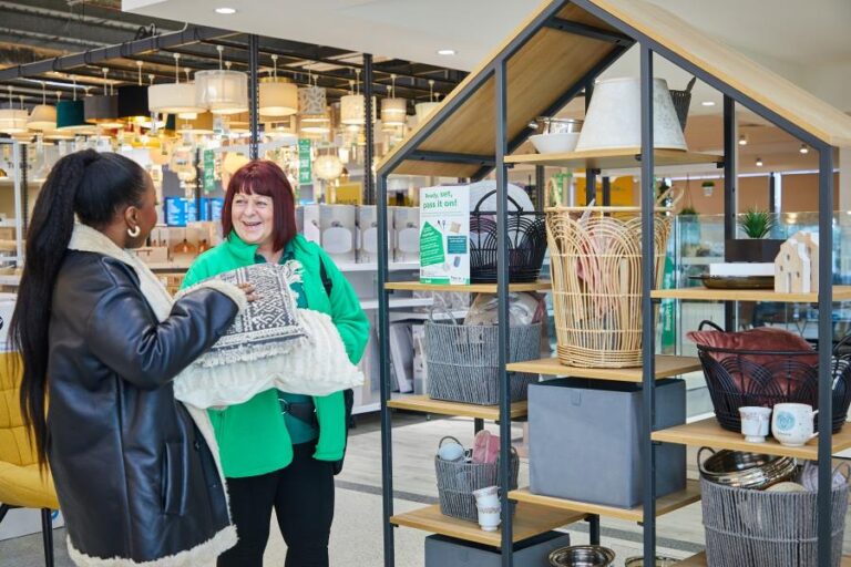 A Dunelm employee talks to a woman dropping off some donations for its Home to Home initiative