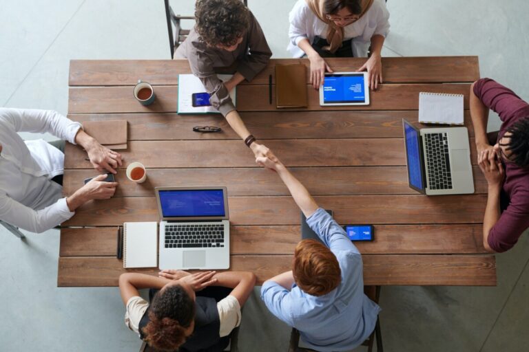 An aerial shot of a business meeting. By Fauxels on Pexels