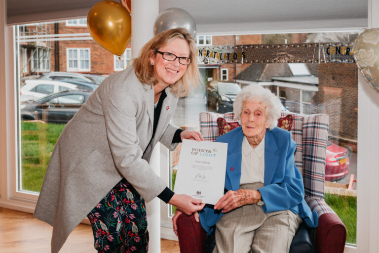 Joan Willet receiving her Points of Light award from MP Sally-Ann Hart. Credit: Simon Booth