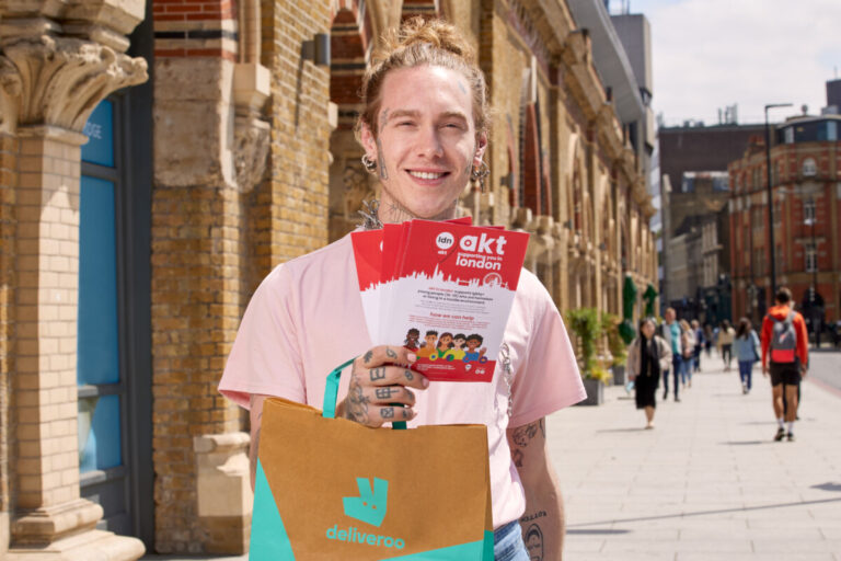 Handing out Akt leaflets and holding a Deliveroo bag