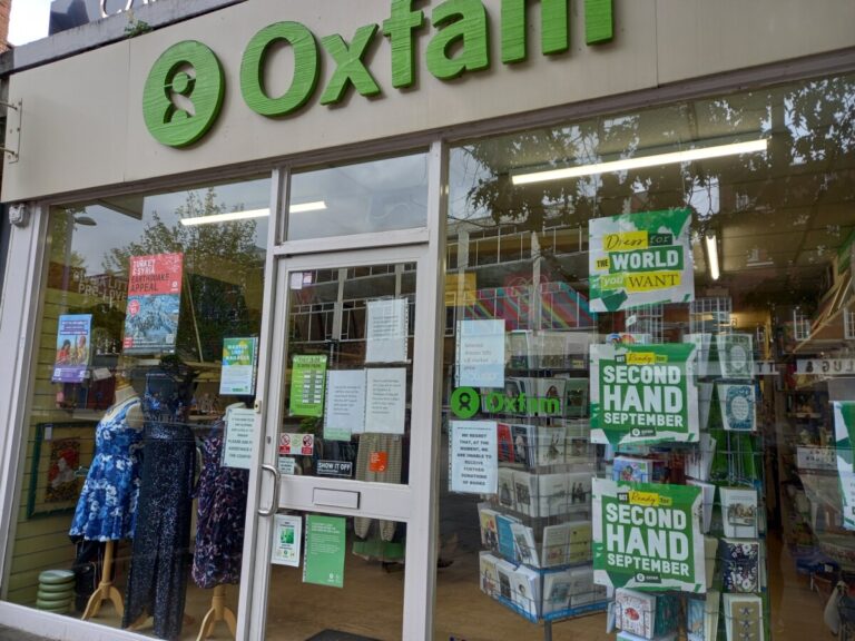 Oxfam shop window with Second Hand September posters in the window