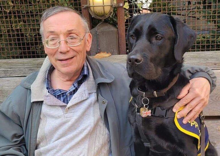 Paul Hicks and a black labrador Guide Dog called Oakley