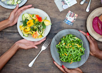 plates of food being placed on a table.