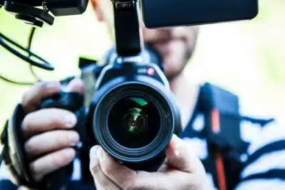 A man looks into a big camera. By Terje Sollie on Pexels