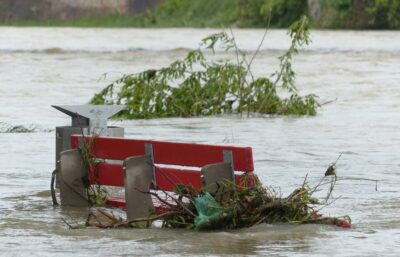 A flood around a park bench by Hans on pexels