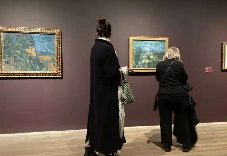 Women looking at paintings in the Tate Modern, London. Copyright: Melanie May