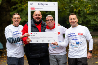 Participants in the Walk for Wellbeing posing with a photo frame