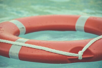 Orange and white lifebouy on water. Image: Unsplash