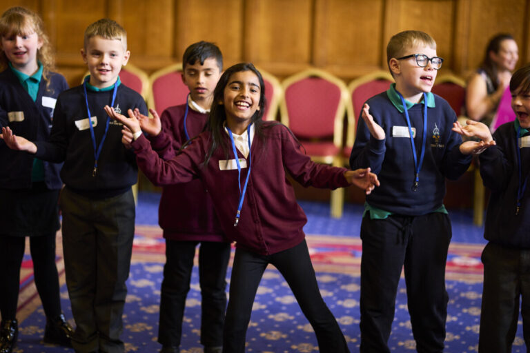 Schoolchildren take part in an event at Bradford City Hall organised by the Linking Network. Photograph: Christopher Thomond/The Guardian