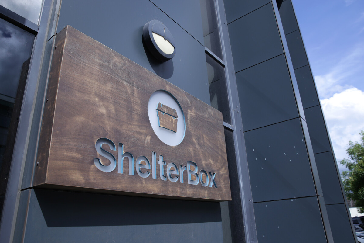 Shelterbox logo on a wooden panel outside their Truro office